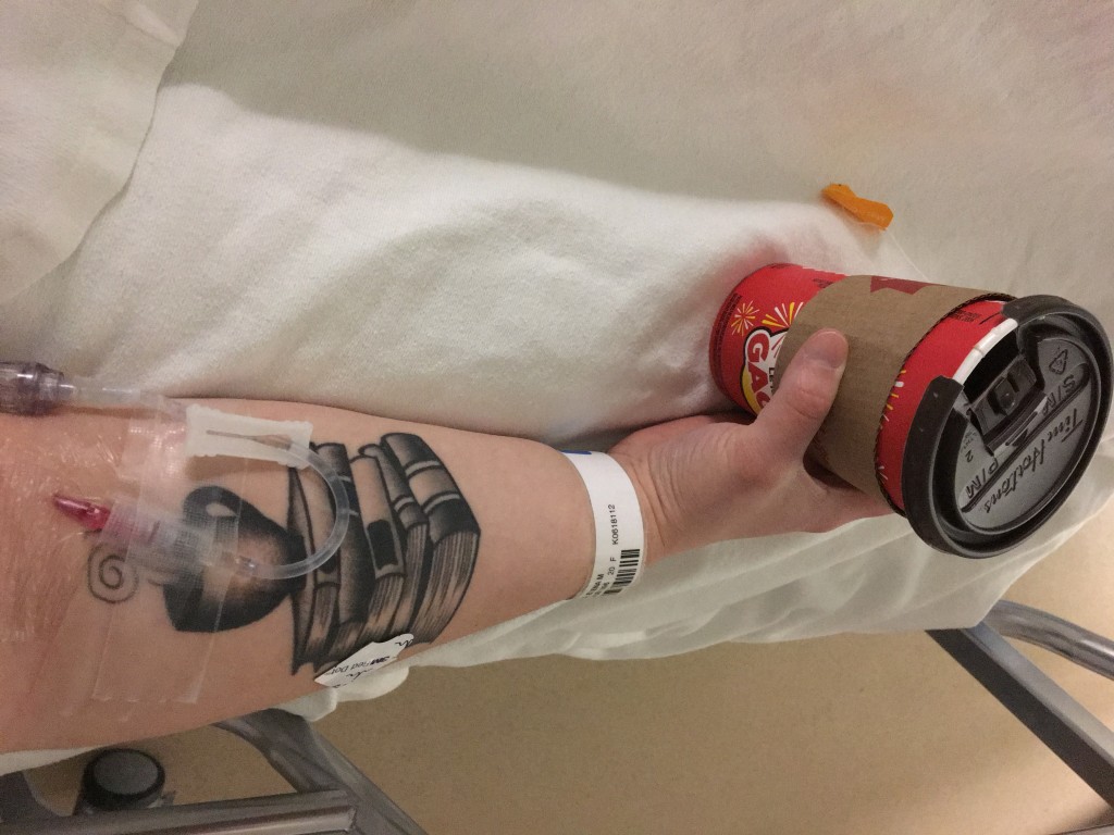 patient holding coffee cup in psych ward with tattoo on arm