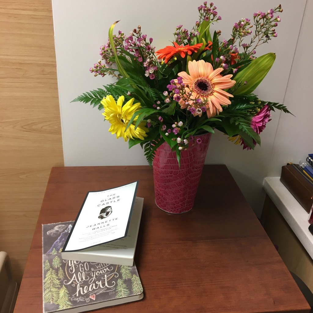 patient's table in psych ward with books and flowers