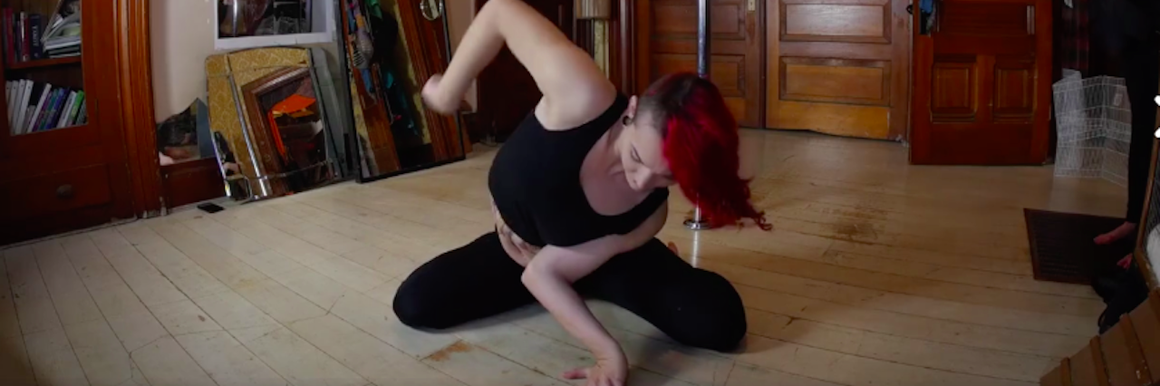 My Response to the Video That Said Ehlers-Danlos Is a Superability woman sitting on floor bending her arm backwards