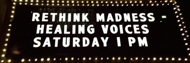 Sign on a movie theater that says: Rethink Madness, Healing Voices