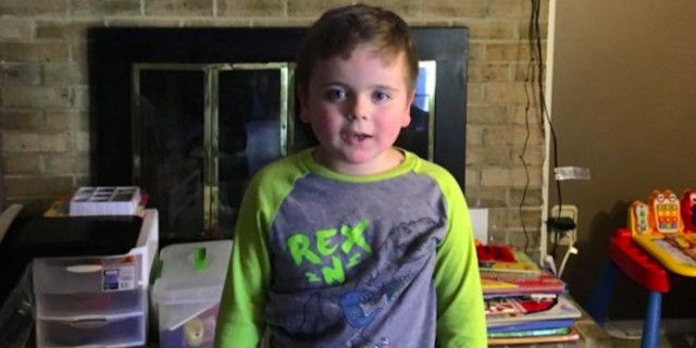 How My Son on the Autism Spectrum Is Using His Voice in His Own Way Boy standing in living room in front of TV with the movie "Finding Dory" on