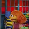 Julia, a new character on Sesame Street, talking with another character