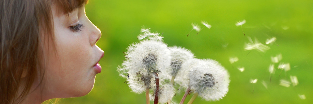 The Mighty: A Letter to the People Who Embrace My Daughter A young girl blowing a dandelion