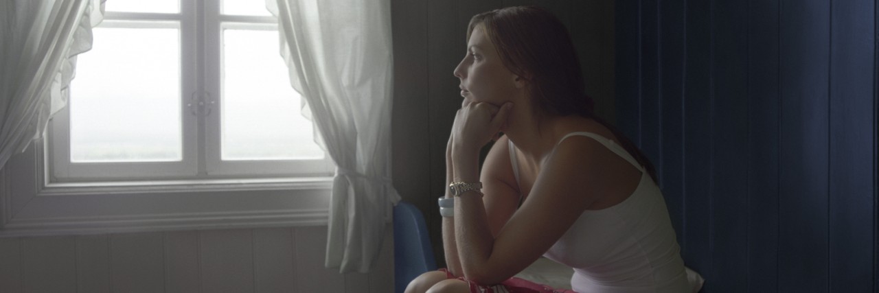 When All You Know Is Depression, It Starts to Feel Like Home Sad Woman Sitting Alone in Room, daydreaming, side view