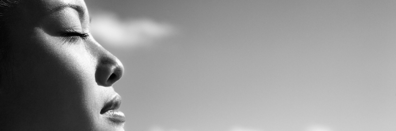 What's It Like for Me as an Undiagnosed Patient Black and white photo of profile of woman's face with eyes closed, cloudy sky background