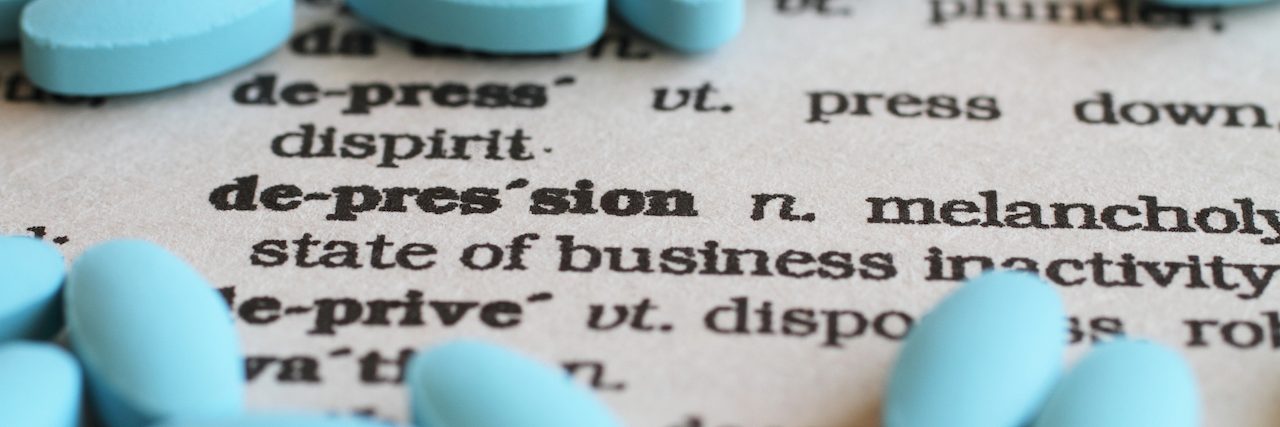 What Doctor's Should Tell You About Antidepressant Side Effects A close up image of the word "Depression" surrounded by pills.