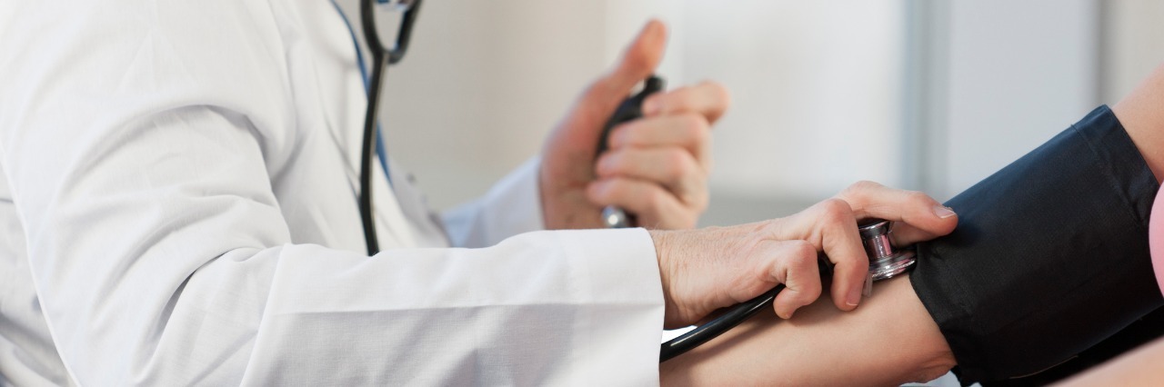 The Ups and Downs of a New Diagnosis Doctor checking patient's blood pressure.