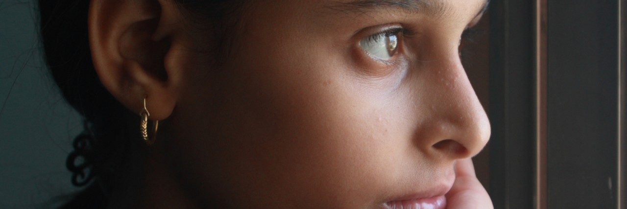 Portrait of teenage girl in window light