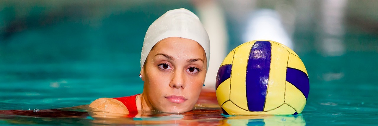 How I Play Water Polo With Perthes Disease Young woman playing water polo in the pool