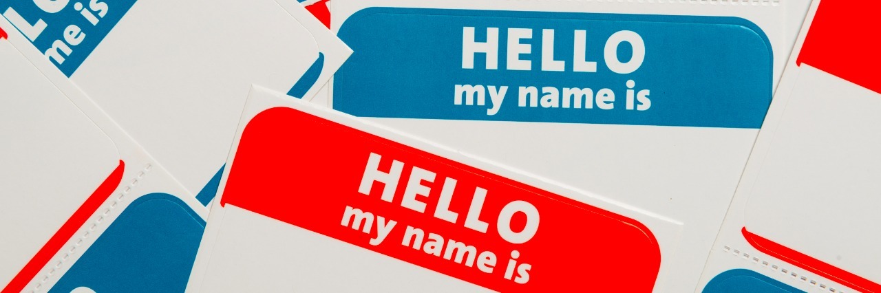 A stack of blue and red "Hello, my name is" name tags or badges
