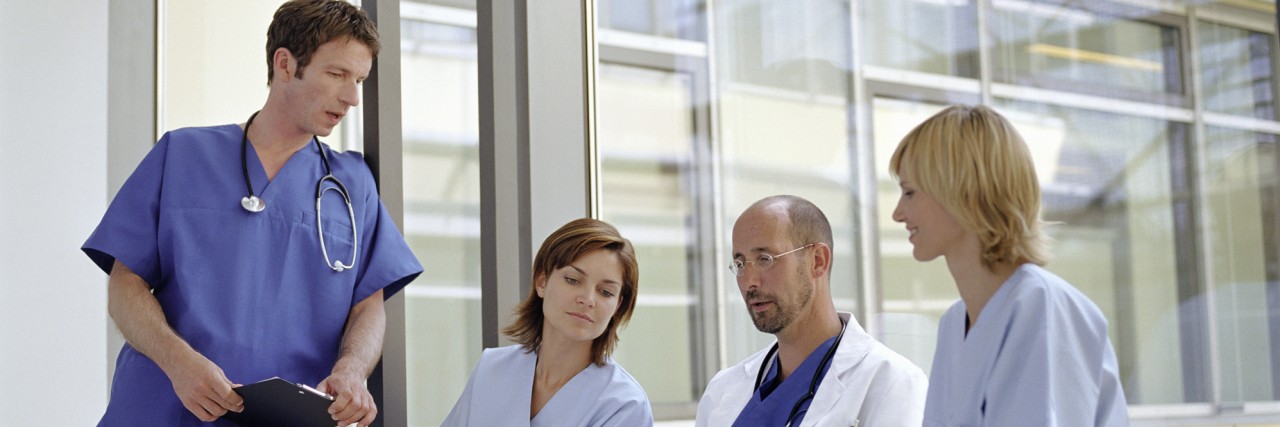 What I Want My Mental Health Crisis Team to Know About Helping Me Doctors and nurses talking by window in hospital