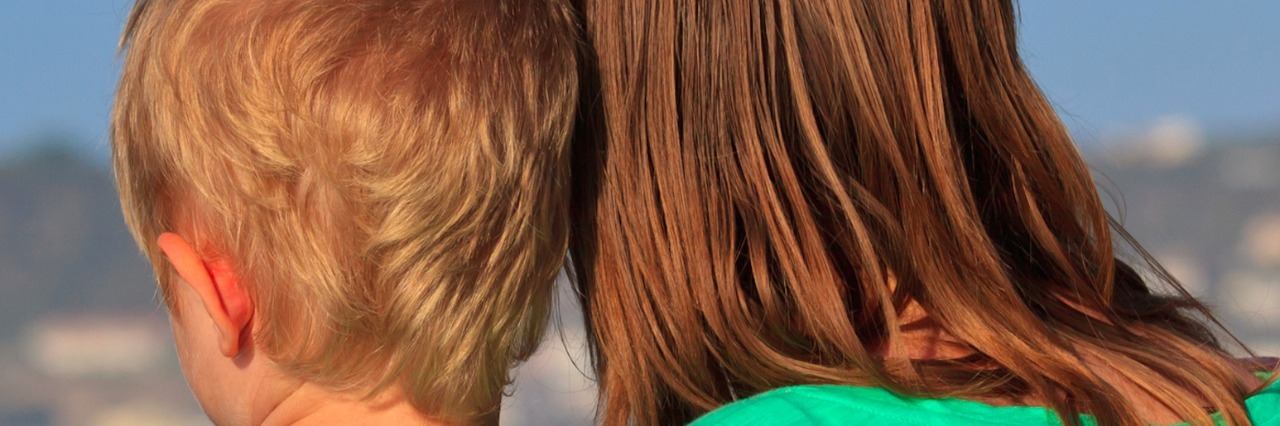 Helping My Son Cope With Grief After the Loss of His Sister mother and son with sides of heads together