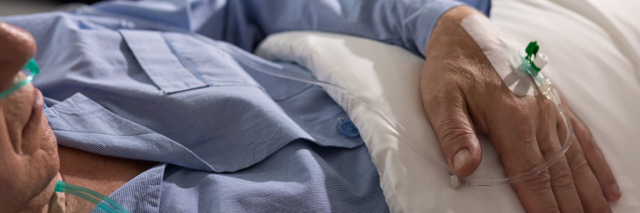 What It Was Like to Watch My Father Die in the ICU Close-up of terminally ill man's hand with drip