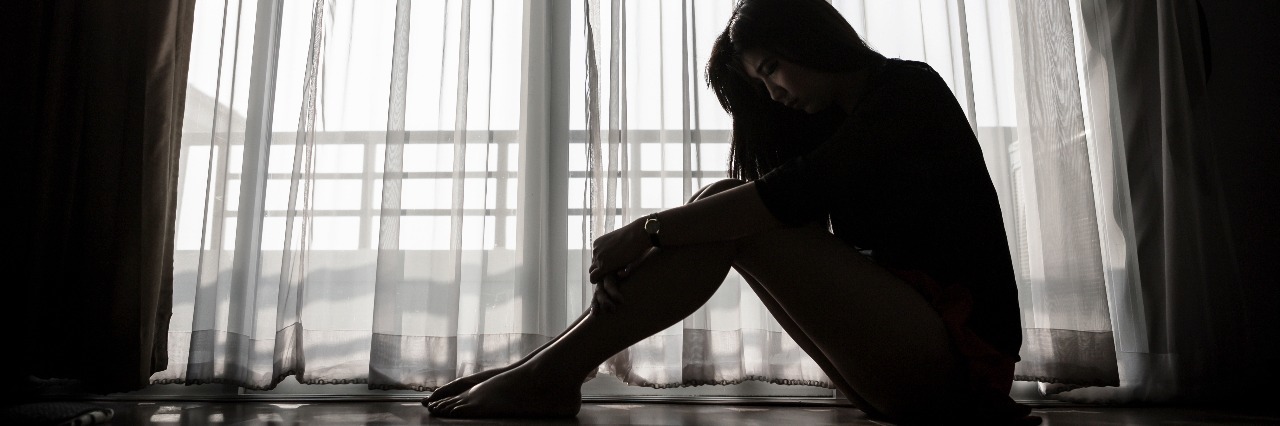 Things You Shouldn't Say to Someone With Complex PTSD woman in black and white in front of window silhouetted