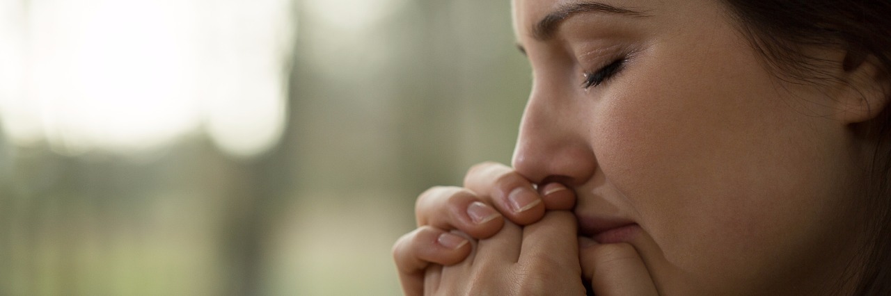 I Felt 'Doomed' by My Schizophrenia Diagnosis profile view of young woman crying depression