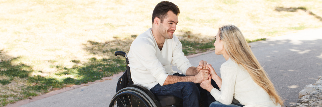 Young man in a wheelchair on a date in the park.