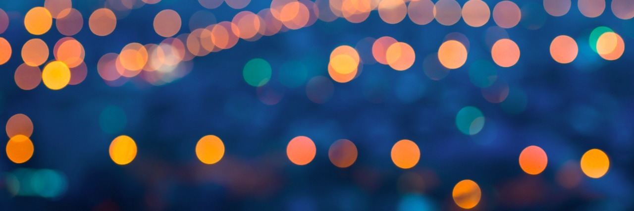 The Pain of Holidays After the Loss of Loved Ones blurred holiday lights against a night sky