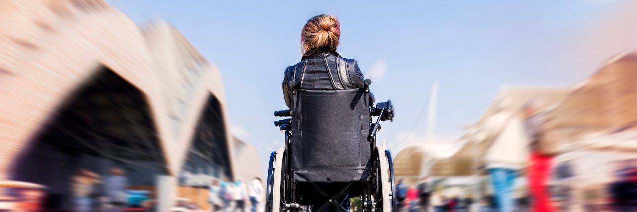 Woman in a wheelchair outdoors.