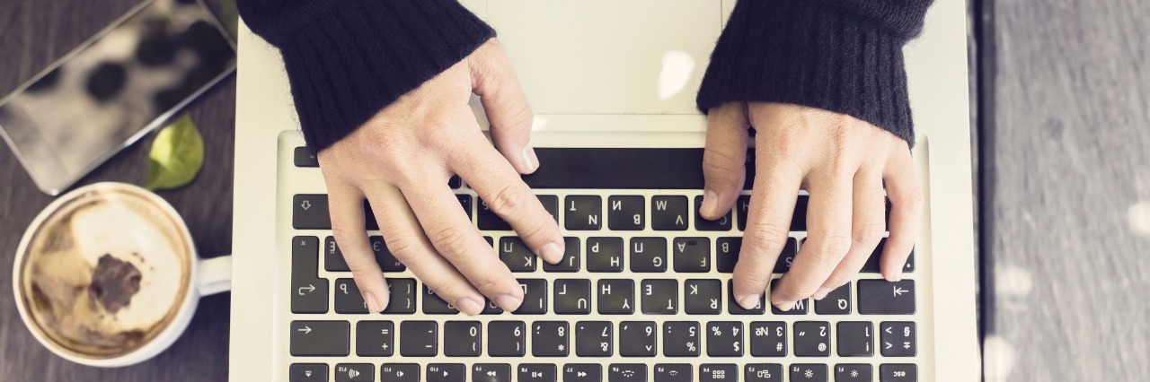 hands typing on laptop