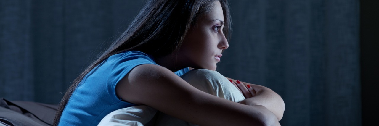 What It's Like to Be Awake at Night With Depression profile portrait of young woman with dark hair awake at night insomnia