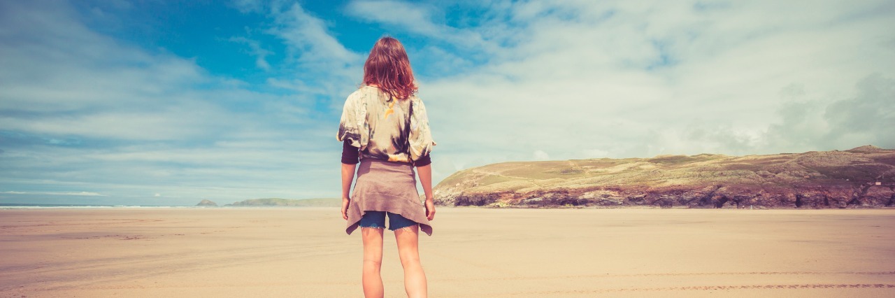 Finding Hope When All Feels Lost Young woman walking on the beach