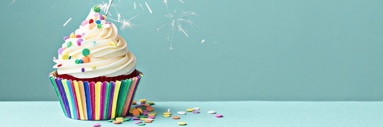 Celebrating the Anniversary of My Diabetes Diagnosis cupcake decorated with colorful sprinkles and a sparkler