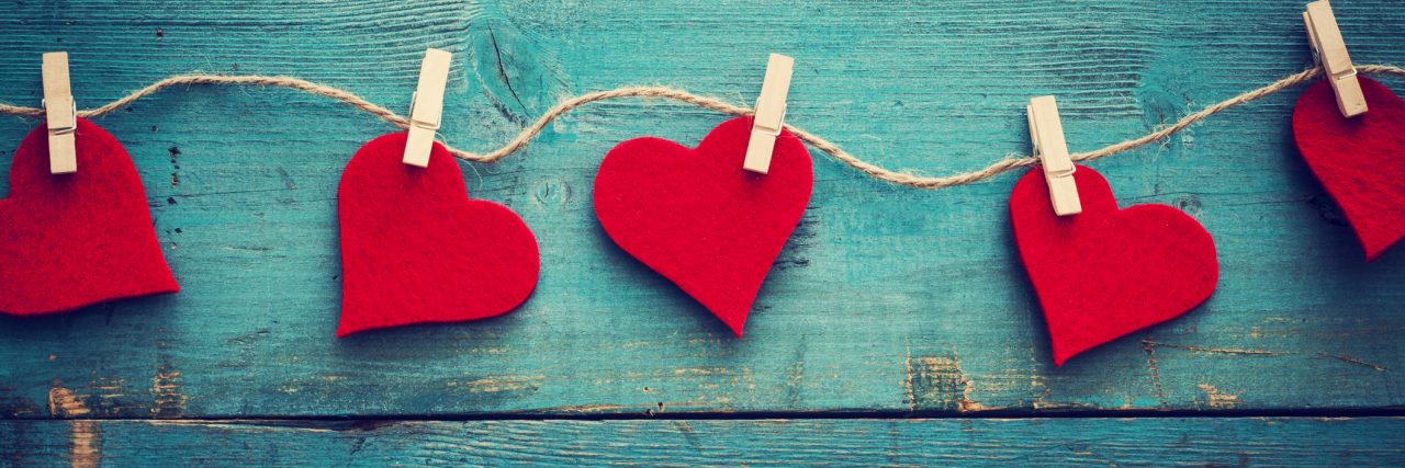 25 Things People With Chronic Illness Want for Valentine’s Day Valentines day hearts on wooden background