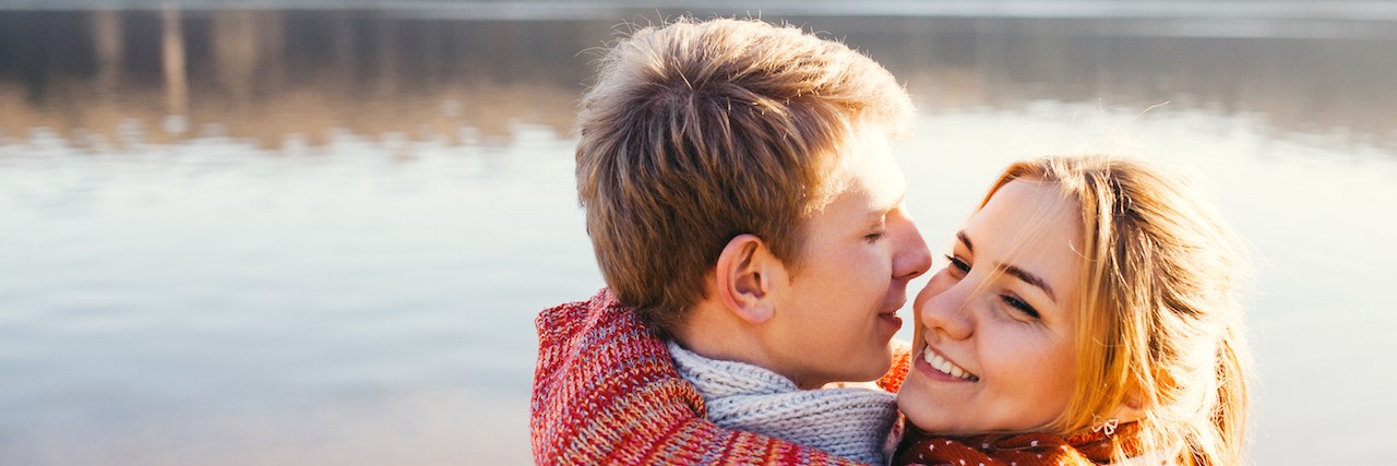 The Struggles of Dating With Anxiety and Depression Young couple in love outdoor at a lake
