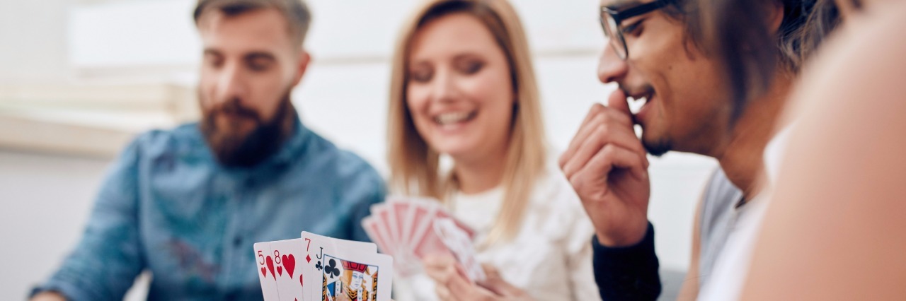 Chronic Illness-Themed Game Ideas group of friends playing a card game