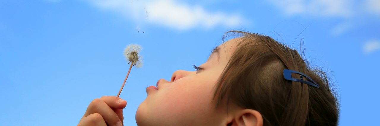 What I'm Celebrating on World Down Syndrome Day Little girl blowing dandelion