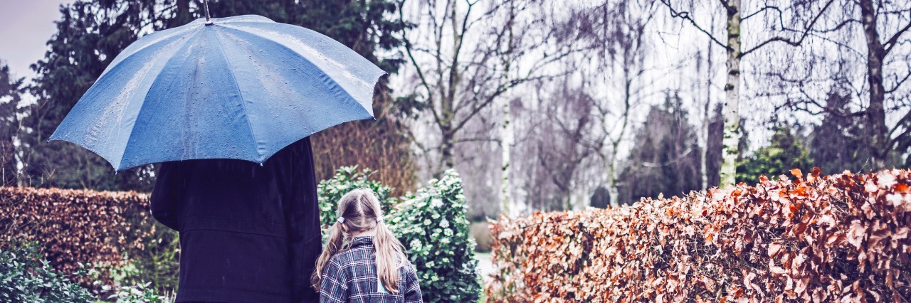Why We Talk About Our Loved Ones Who Have Died Father and daughter visiting gravestone of deceased mother