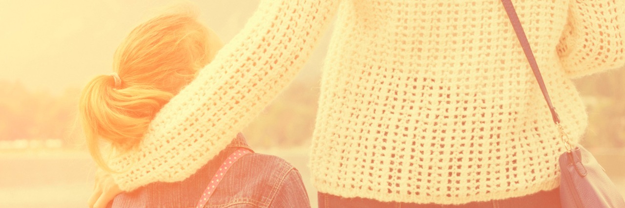 Why These Negative Responses to My Child’s Autism No Longer Anger Me Mom with arm around daughter's shoulders, with lake in the background