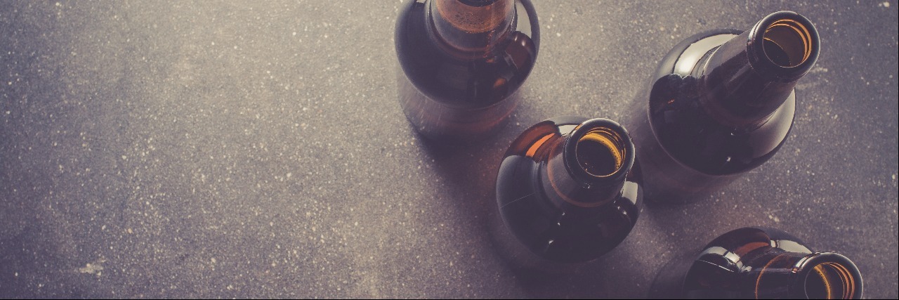 close up of beer bottles on a dark table