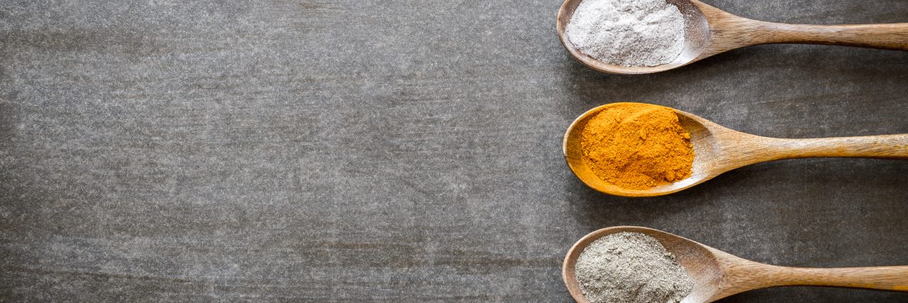 Various spices on wooden spoons