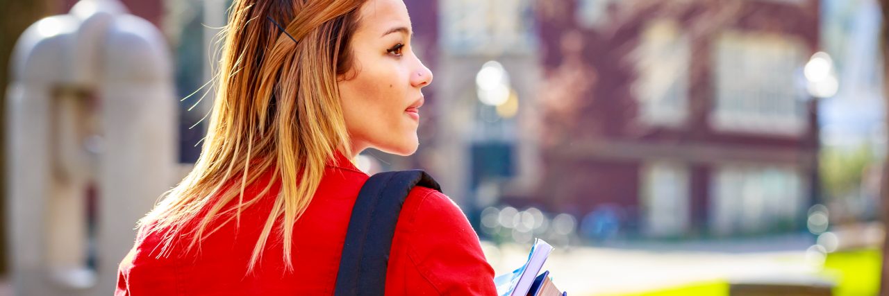 A young female college student between classes.