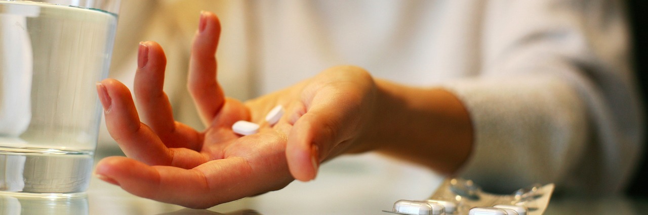 How Taking Medication for Mental Illness Affects Everyone Differently A woman holding pills in her hands