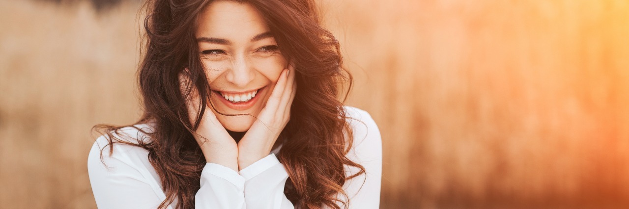 Why Using Humor to Answer 'Are You OK?' Helps in My Mental Illness portrait of woman laughing in nature and sunshine