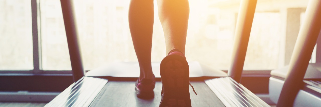 close up of woman's feet running on treadmill