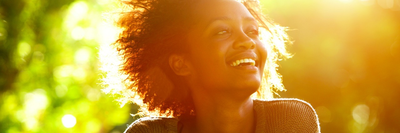 Close up portrait of a woman smiling with sunset