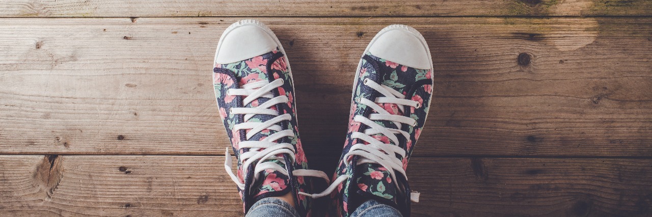 The Importance of Taking Little Steps in Anxiety Recovery floral pattern sneakers standing on old wooden floor
