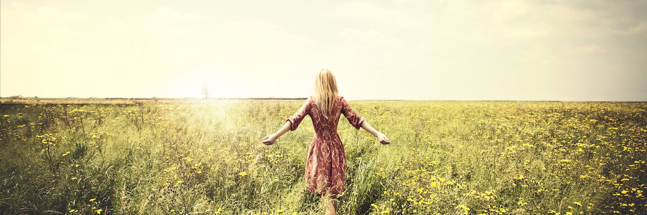 Accepting My Life With Anxiety A woman sitting in a field