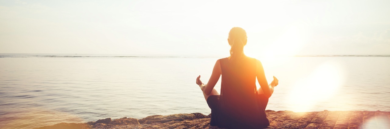 Learning to Be Patient With Myself With Anxiety Woman doing meditation practice on the beach