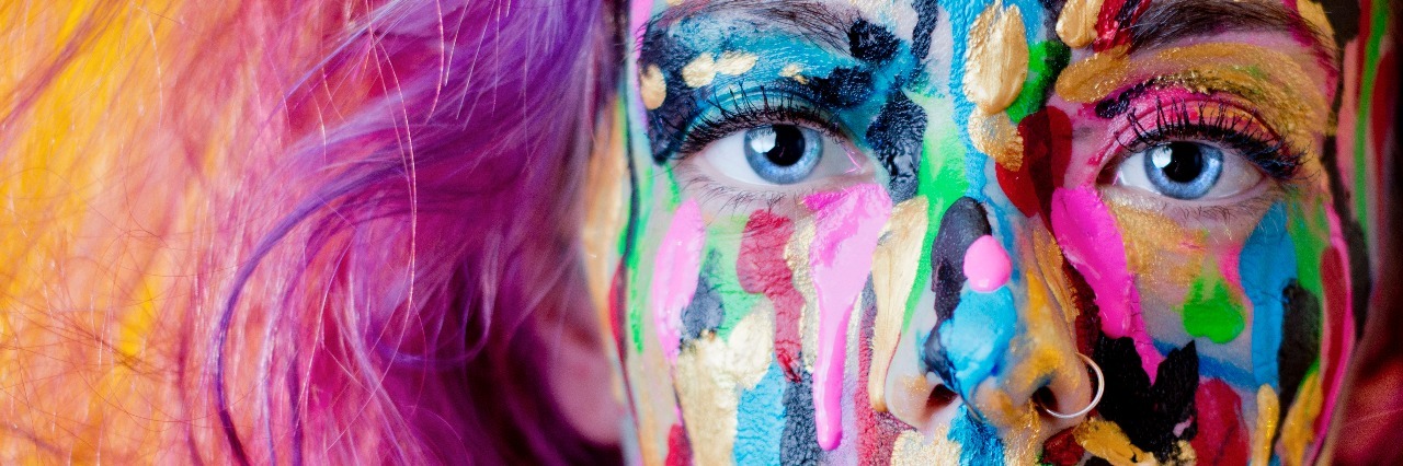 The Invisible Parts of an Eating Disorder: Ending the Stigma close up woman with purple hair covered in paint