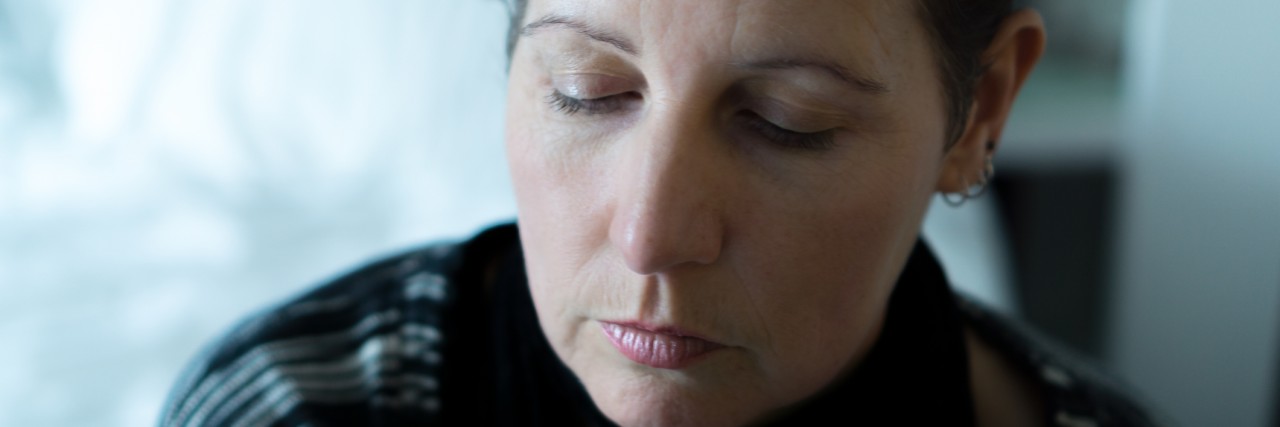 A Letter to My Children, From Their Depressed Mummy A middle aged woman looking pensive and sad