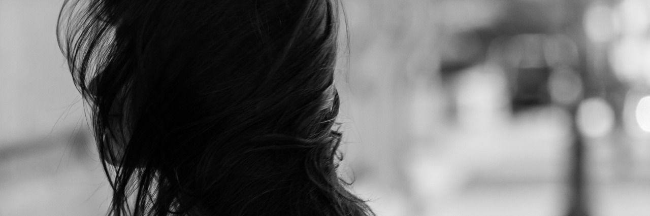 25 Things People Don't Realize You're Doing Because of Gastroparesis girl turning head with hair blowing over her face