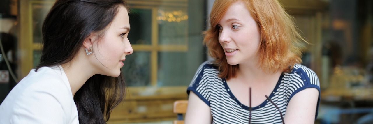 What to Know Before Offering Health Advice to a Sick Loved One two women talking outside at a cafe