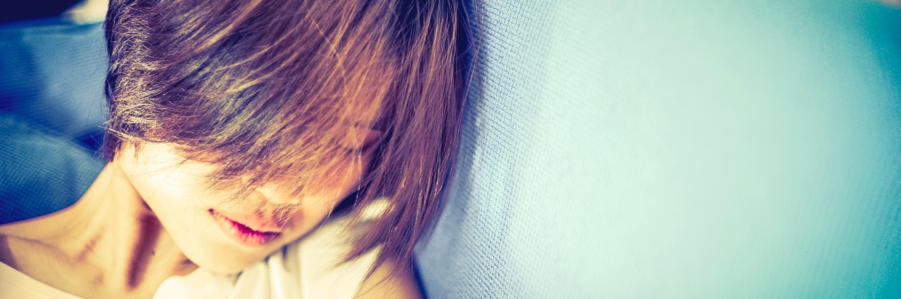 Why Daily Life Is Hard When You Have Chronic Fatigue Syndrome Short Hair Vintage Hipster Asian Girl. Short Hair Japanese Teenager sleeping on sofa. With copy space. Vintage Sepia color tone.