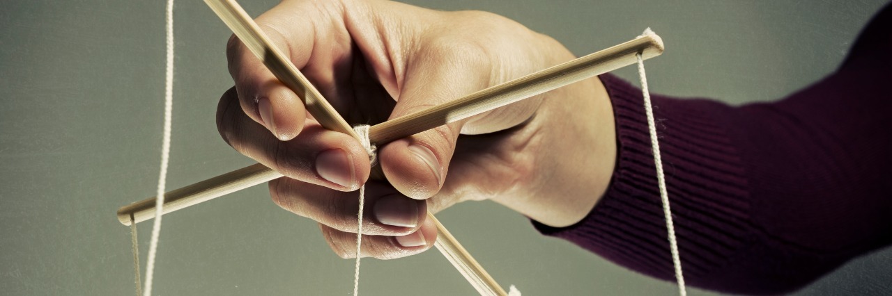 How My Eating Disorder Controls Every Moment of My Life arm with puppet strings controlling unseen puppet