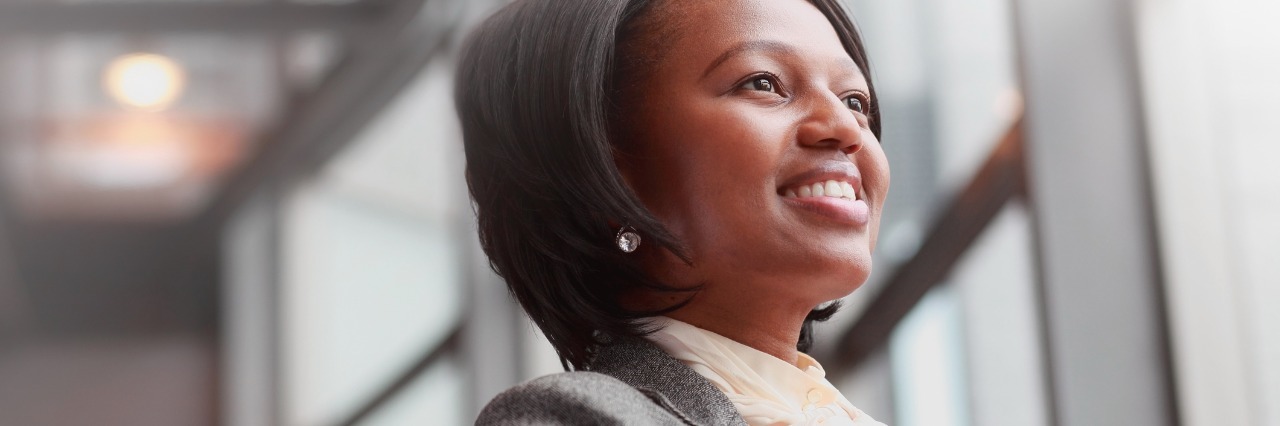 Sickle Cell Disease: Managing Your Health, Taking Charge of Your Care woman smiling and looking out a window