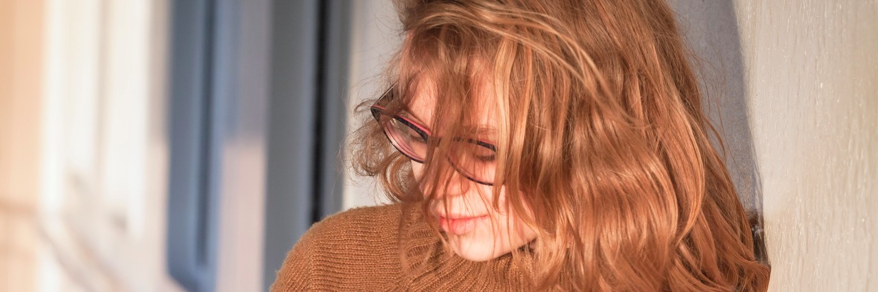 The First Time My Friend Saw My Self-Harm Scars Beautiful blond teenage girl in glasses and warm sweater